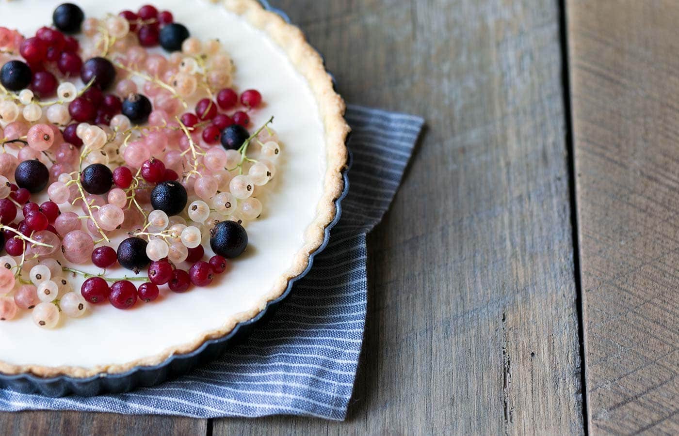 This Mixed Currant Panna Cotta Tart is a light, beautiful dessert that will wow your guests! SavorySimple.net