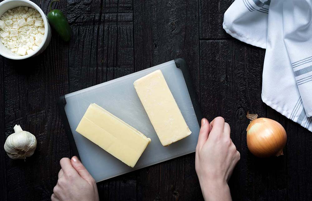 Preparing cheese for homemade queso blanco dip.