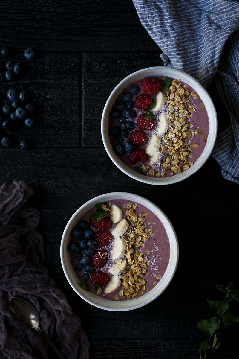 Overhead shot of smoothie bowl recipe topped with fruit and granola