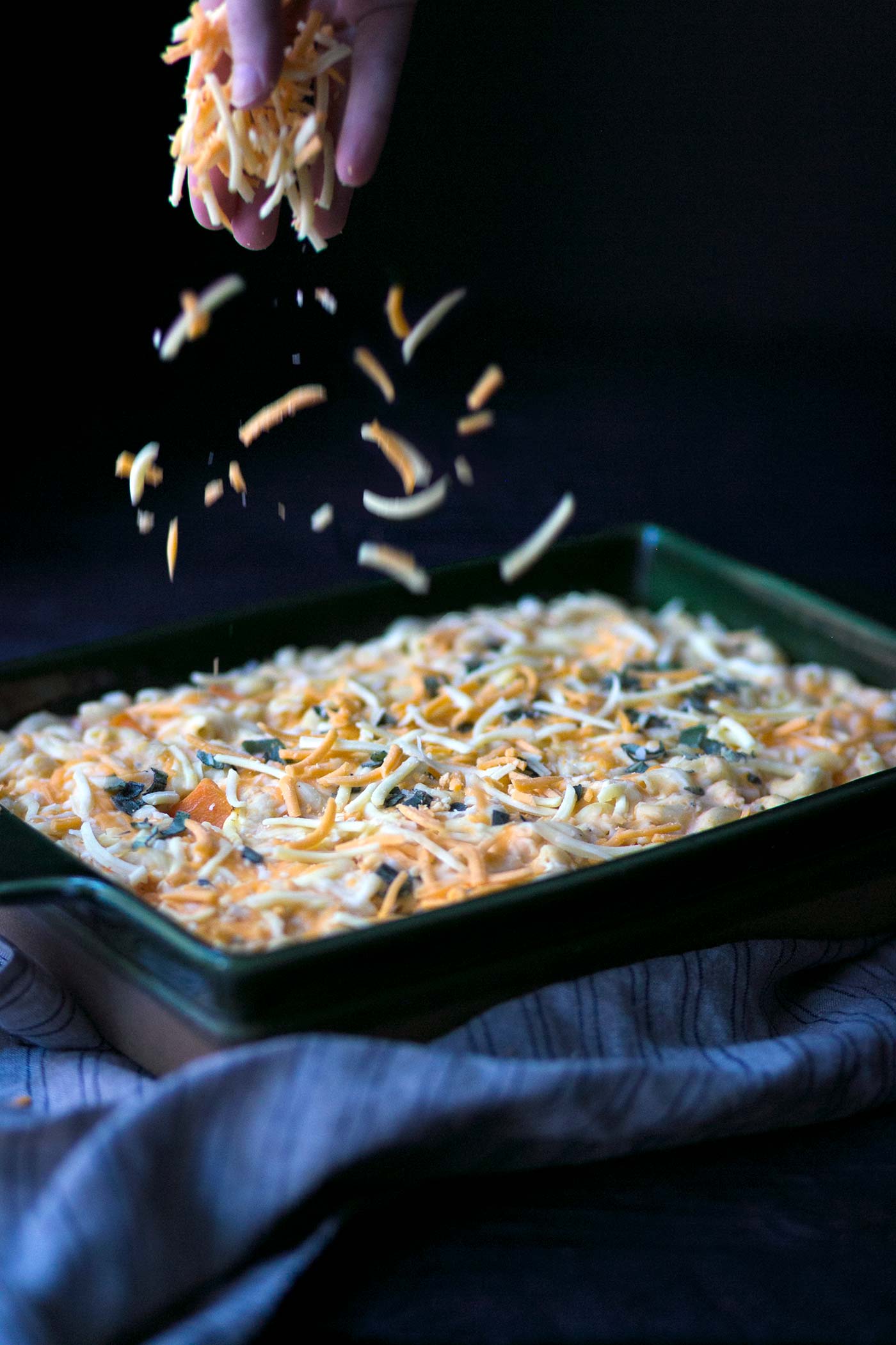 Topping butternut squash mac and cheese with more cheese.
