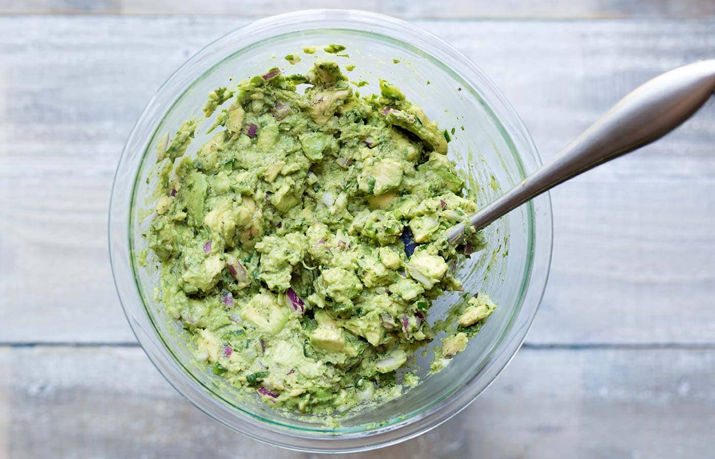 Learn how to make perfect guacamole that will stay fresh and bright green for days! Get the recipe and technique from Savory Simple.