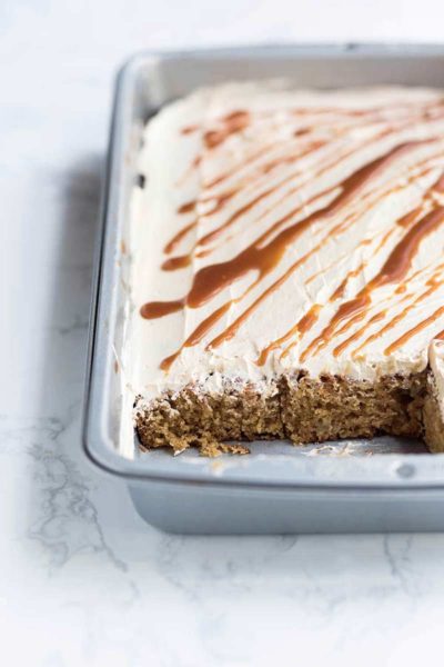 Salted Caramel Apple Cake recipe in a 9x13 pan with several slices missing