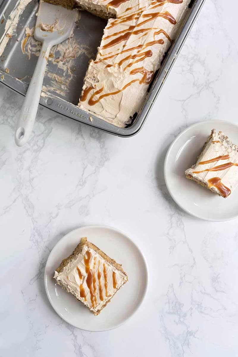 A photo of the finished cake sliced with two pieces on plates.