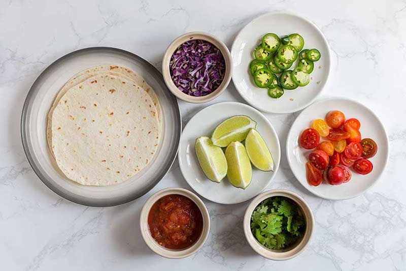 A photo of chicken taco fixings. 