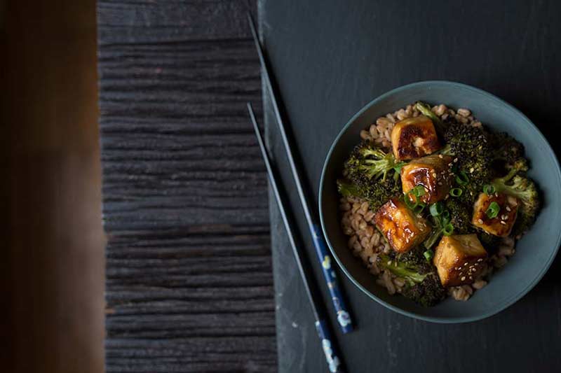 an overhead shot of crispy tofu and broccoli served over rice