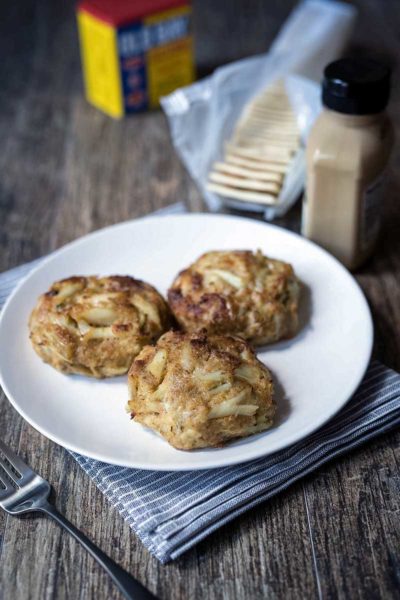 A photo of three of the best broiled Maryland crab cakes on a plate.