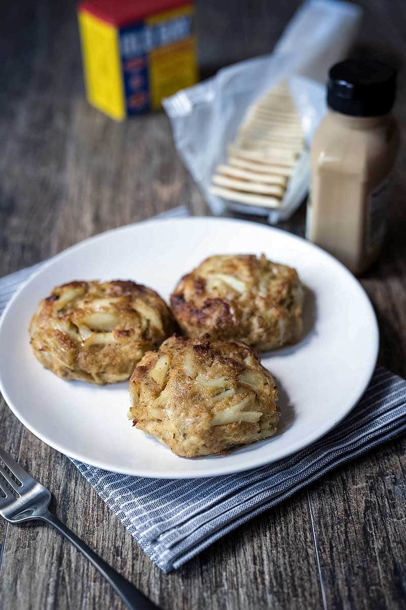 A photo of three of the best broiled Maryland crab cakes on a plate.