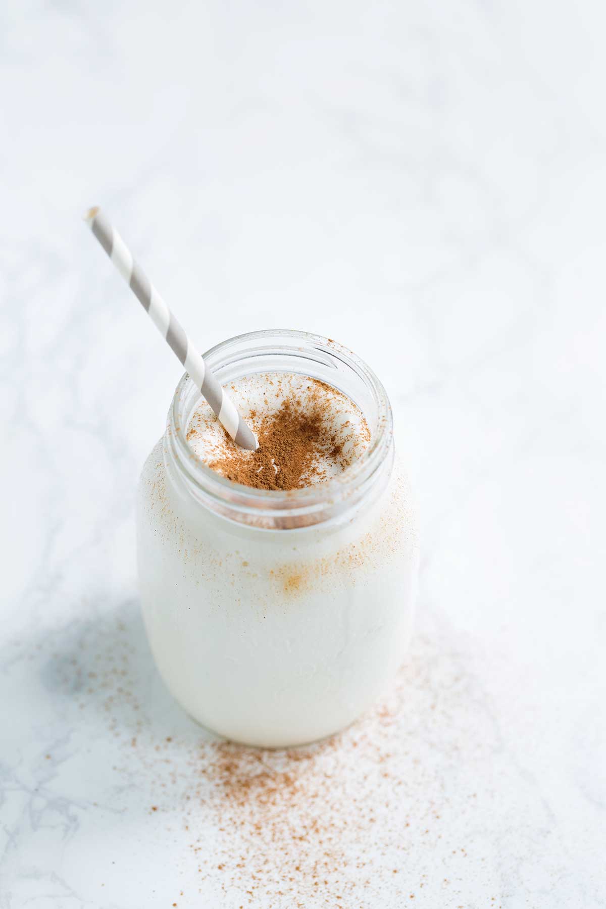 RumChata milkshake in a mason jar, topped with cinnamon.