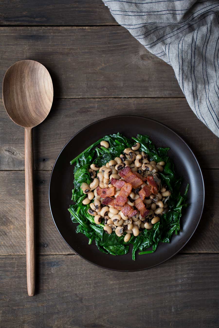 Did you know that enjoying black eyed peas on January 1st is considered by some to bring luck and prosperity in the new year? It never hurts, right? This hearty recipe for Black Eyed Peas with Bacon and Spinach is a savory winter treat.