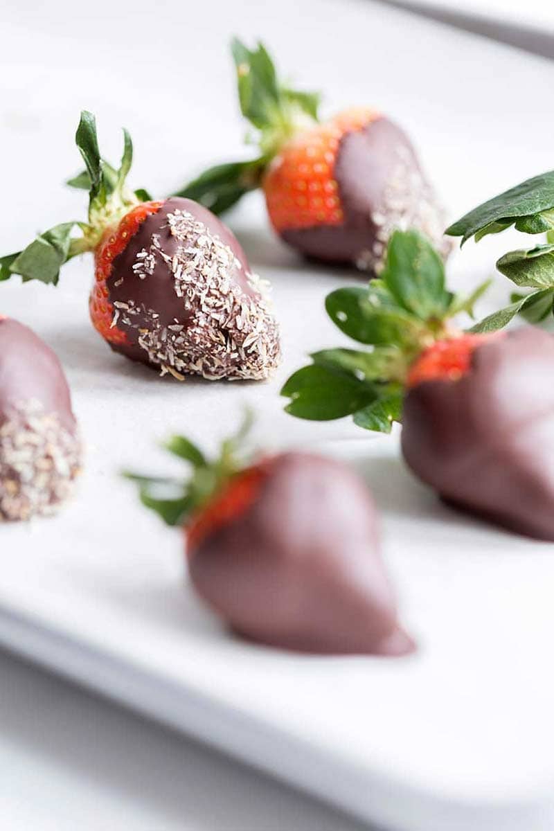 A photo of chocolate strawberries coated in toasted coconut.