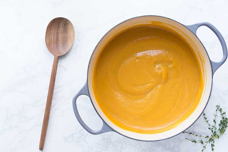 Photo shows homemade butternut squash soup recipe in a saucepan.