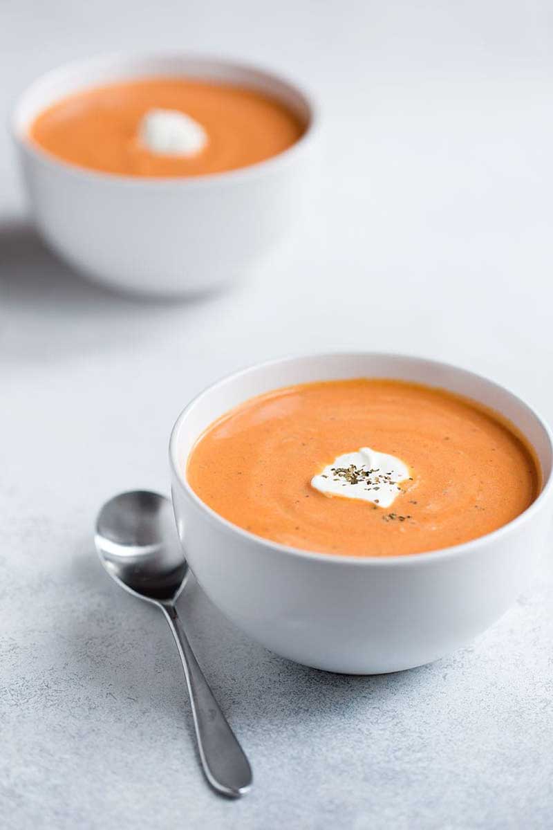 A birds eye photo of tomato bisque soup.