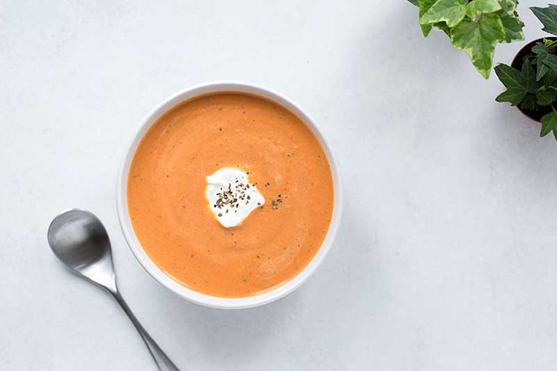 An overhead photo of tomato basil soup.