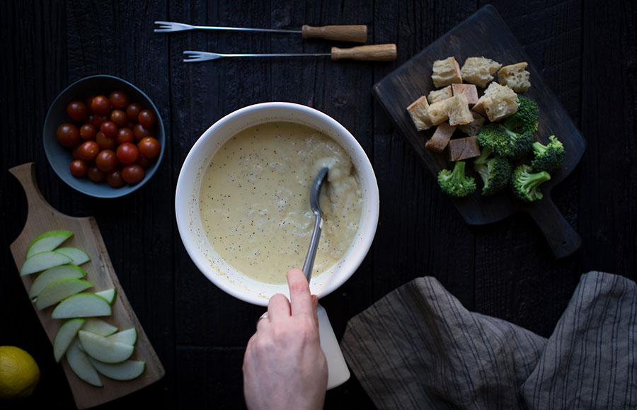 Stirring cheese fondue.
