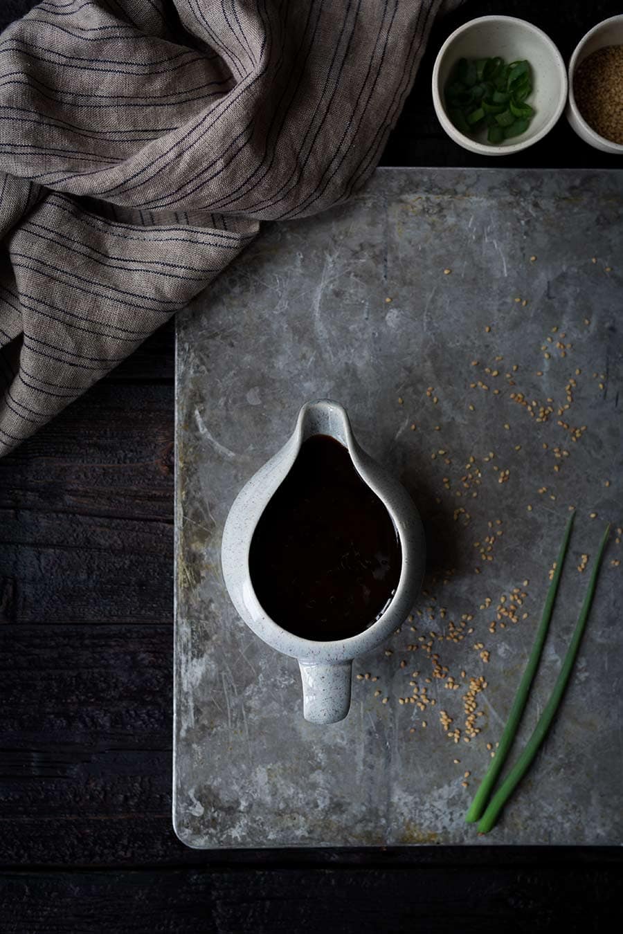 homemade teriyaki sauce in white pitcher on gray counter