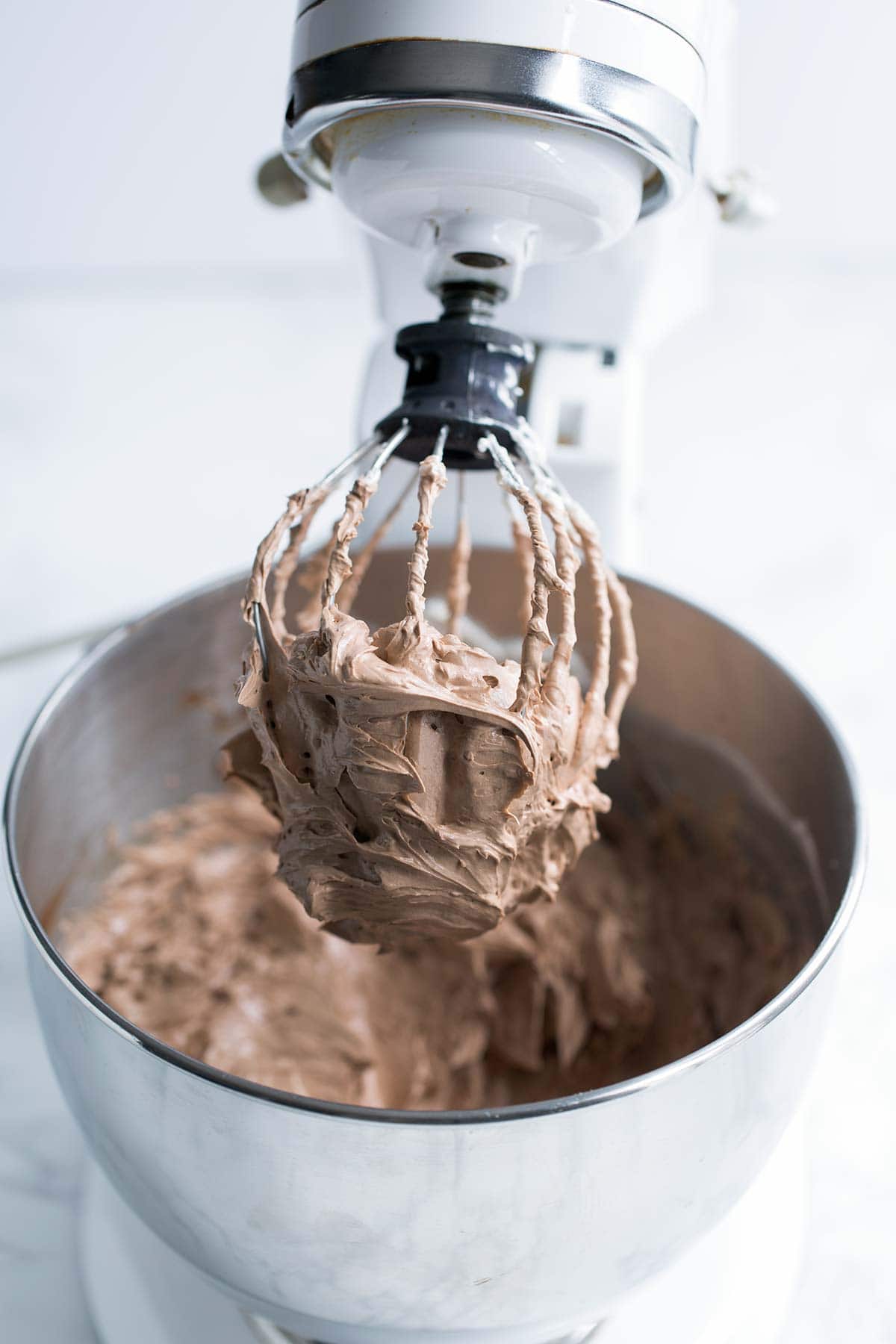 Finished chocolate buttercream frosting in a stand mixer.