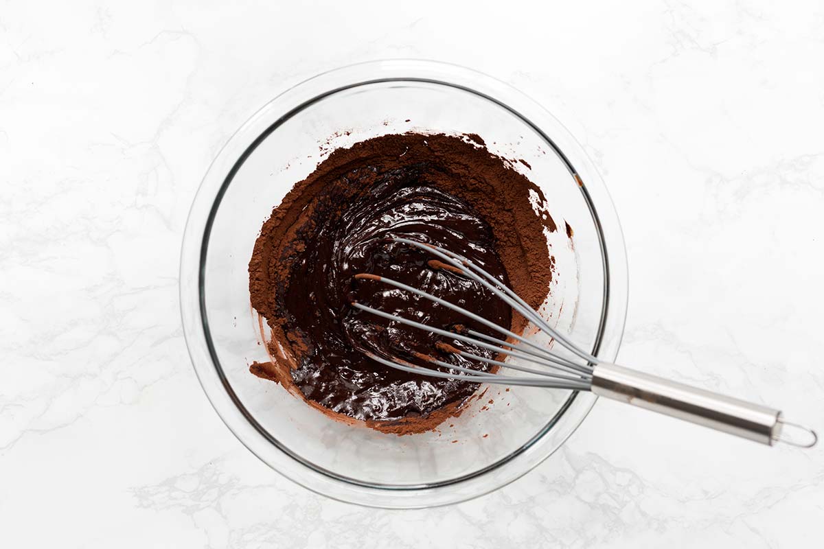 melted chocolate and cocoa powder in a bowl with a whisk; two ingredients worth splurging on