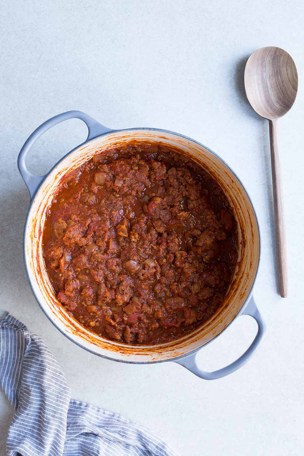 A large dutch oven filled with meat sauce for pasta.