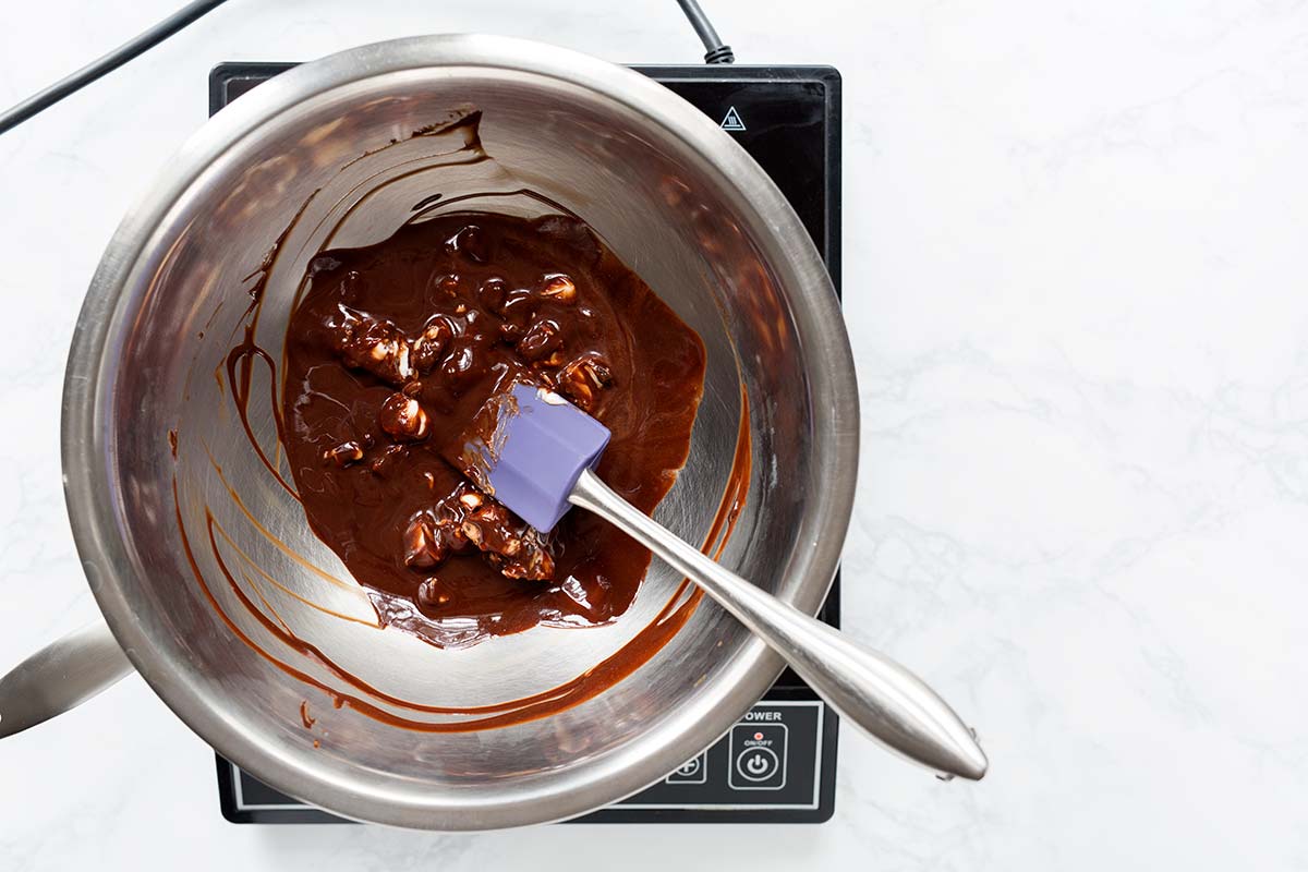 Melting unsweetened chocolate and butter over a double boiler for chocolate frosting.