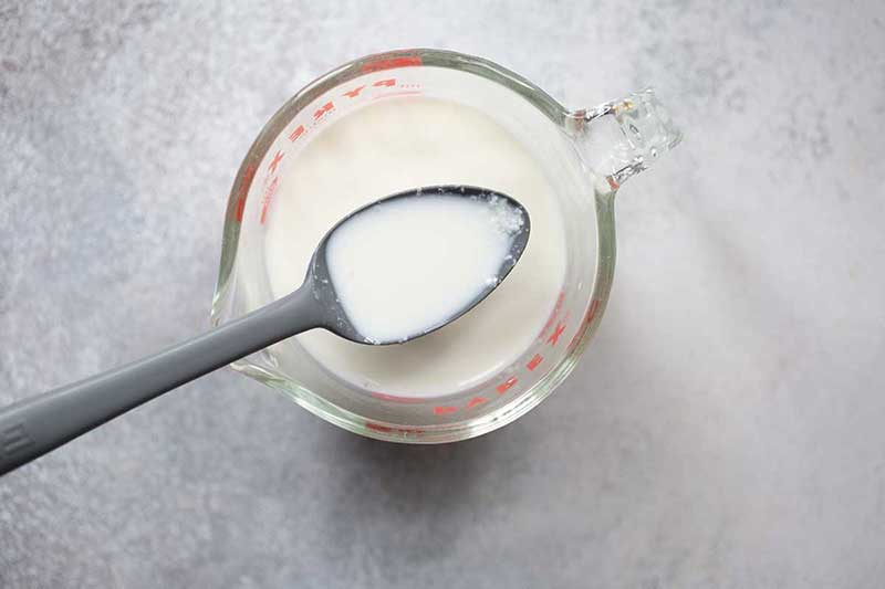 A spoonful of curdled, homemade buttermilk recipe.