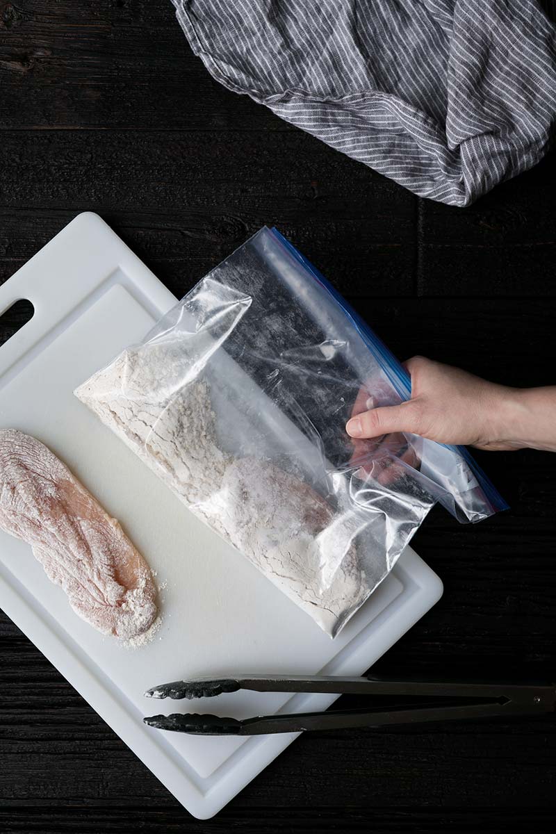 Chicken breasts that have been dredged in a mixture of flour, salt and pepper using a resealable plastic bag. 