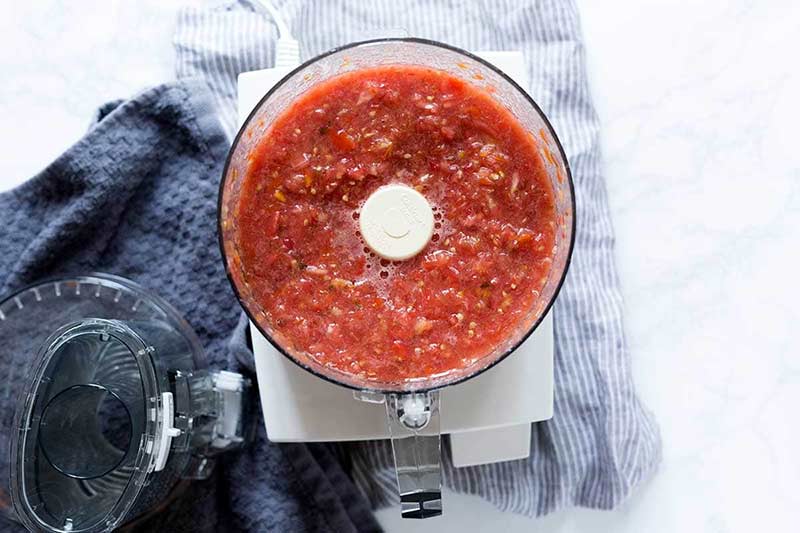 Pureed tomatoes in a food processor.