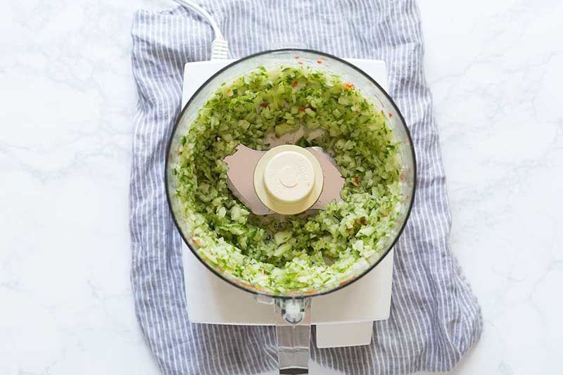 Chopped cucumbers in a food processor.