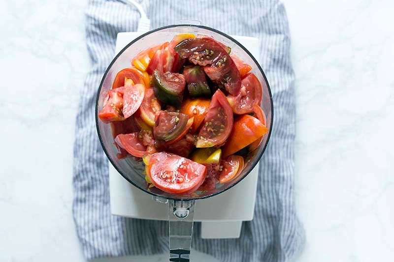 Chopped tomatoes in a food processor.