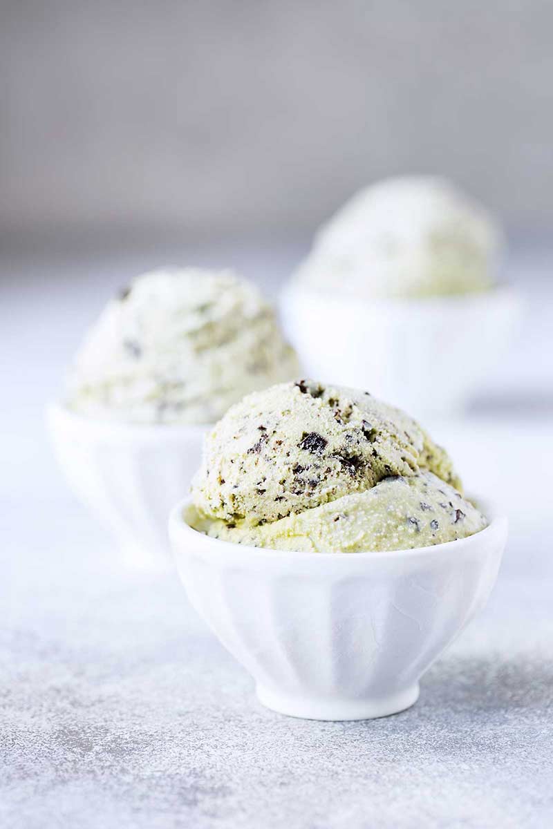 Three bowls of homemade mint chocolate chip ice cream recipe.
