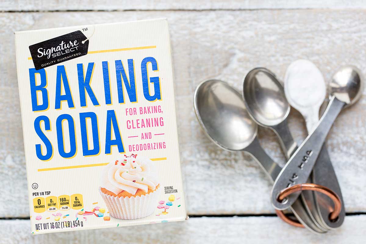 A photo of baking soda and measuring spoons