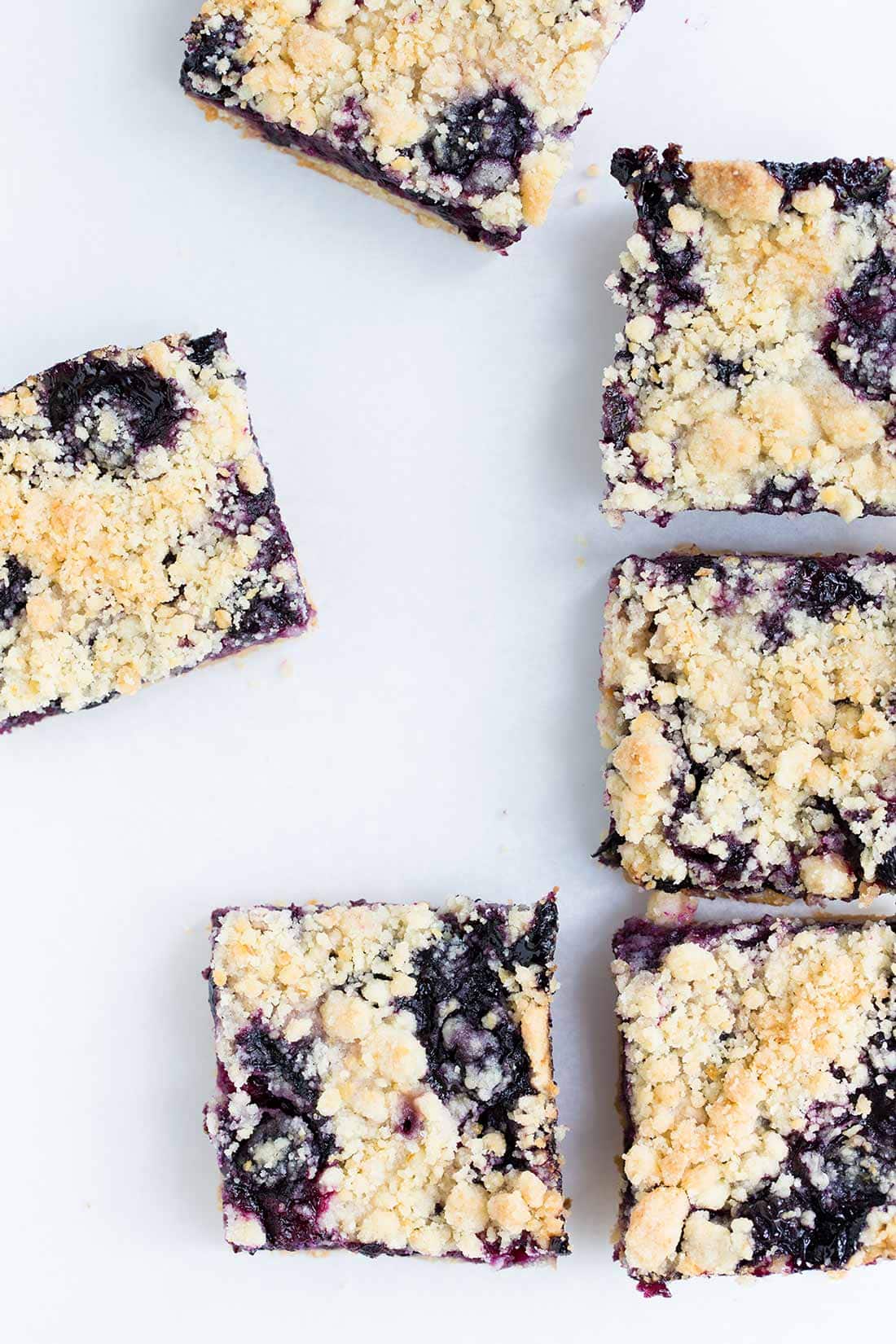 Blueberry bars on a cutting board, shot from overhead
