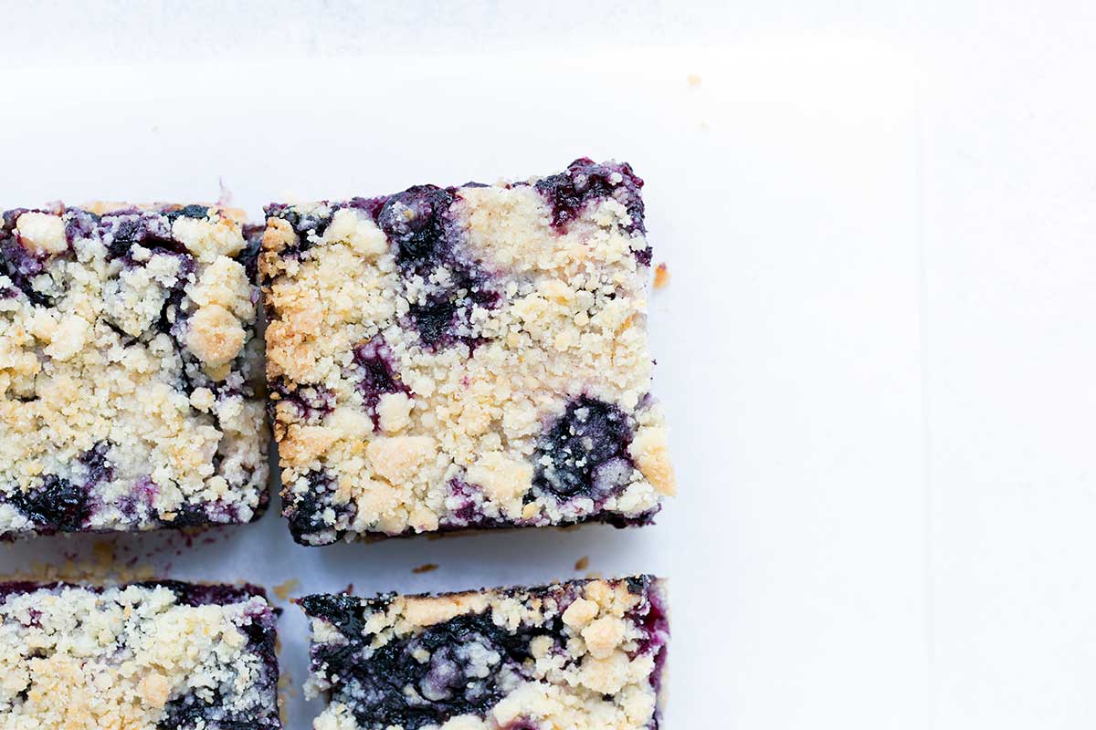 Finished, sliced blueberry crumb bars, shot from overhead.