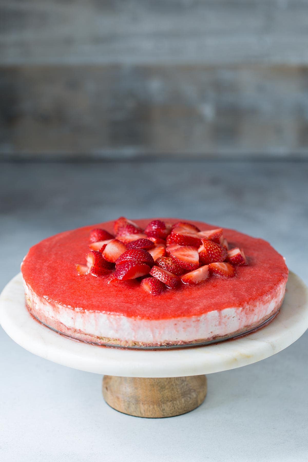 An easy no bake cheesecake recipe topped with strawberry puree and fresh strawberries. 