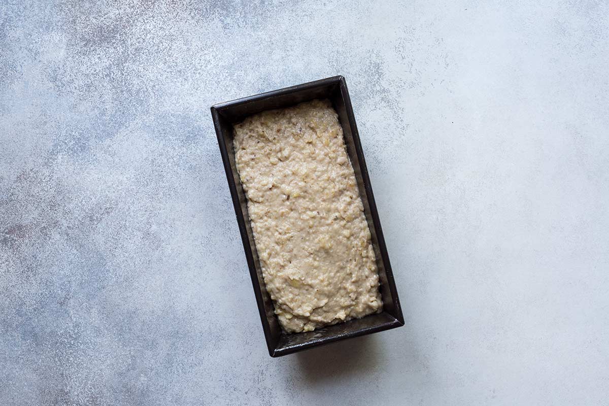 Banana nut bread batter in a loaf pan