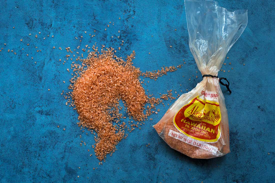 Hawaiian Sea Salt for Kalua Pork spread on a blue backdrop