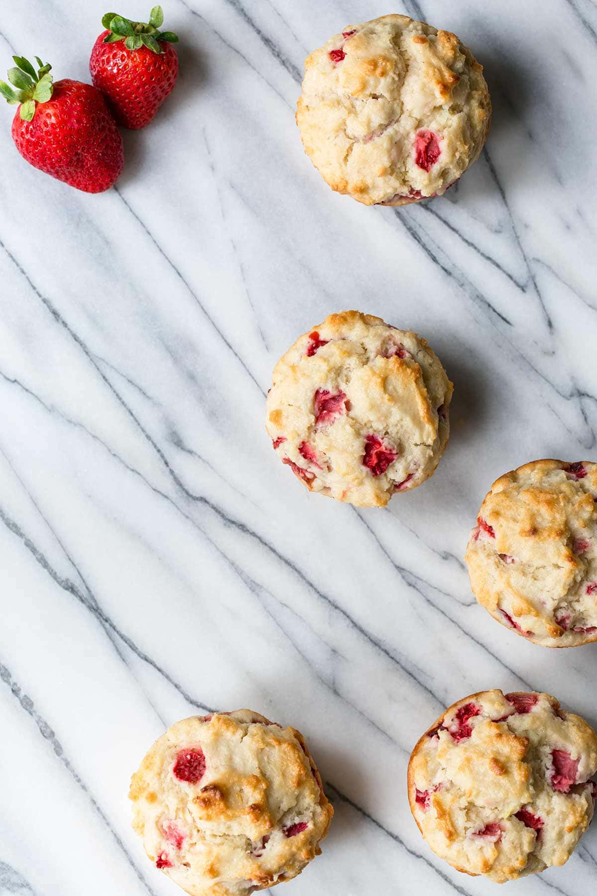 Strawberry jumbo muffins on a marble board
