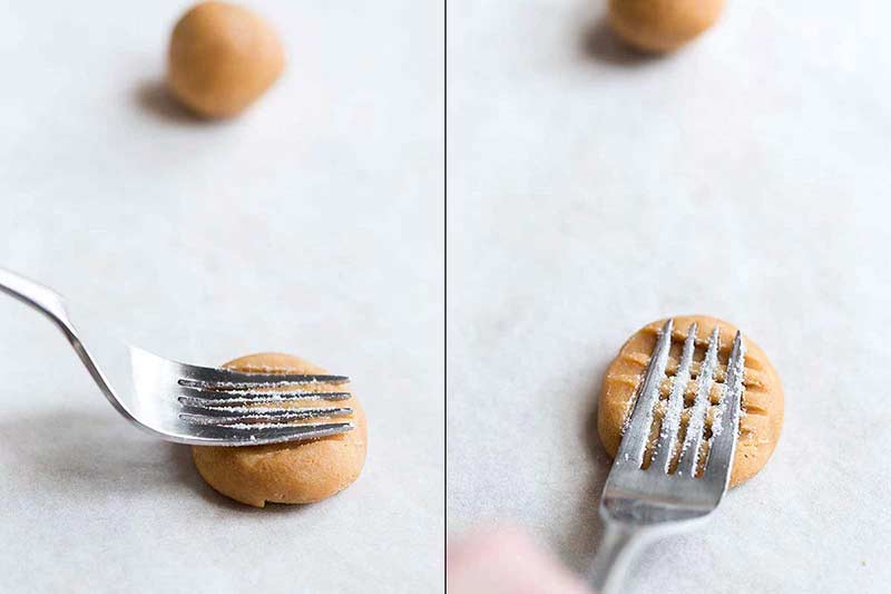 Using a fork to make a crisscross pattern on balls of raw cookie dough