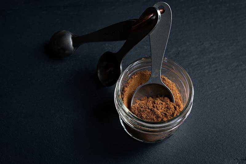Homemade Pumpkin Pie Spice Recipe in a mason jar with measuring spoons
