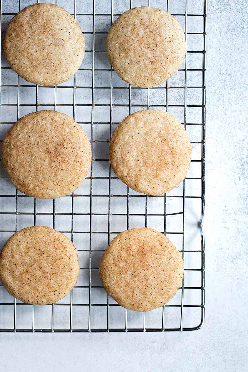 Snickerdoodle cookies on a cooling rack.