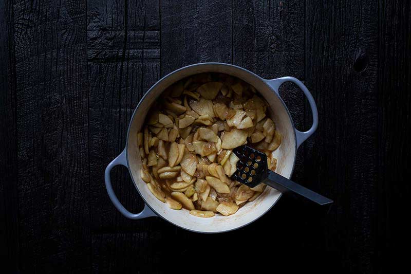 Apple pie filling in a Dutch oven.