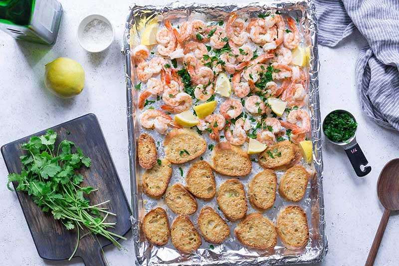 Sheet pan topped with cooked shrimp and bread
