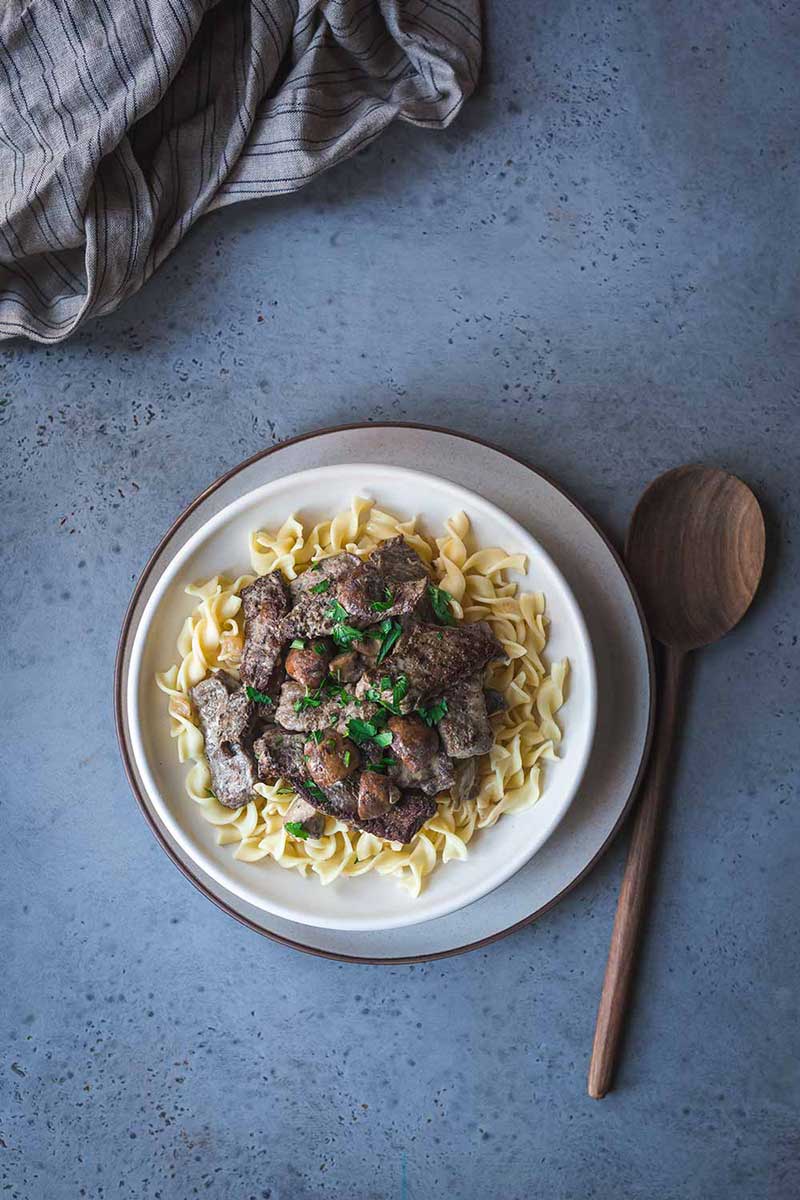 Beef Stroganoff recipe over pasta in a bowl