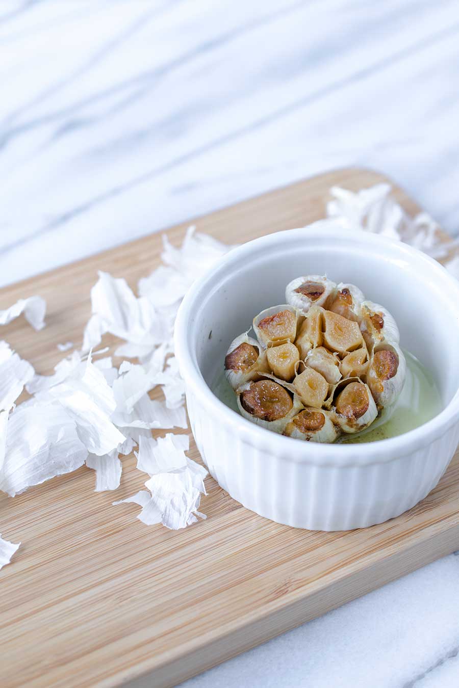 A photo of roasted garlic in a ramekin