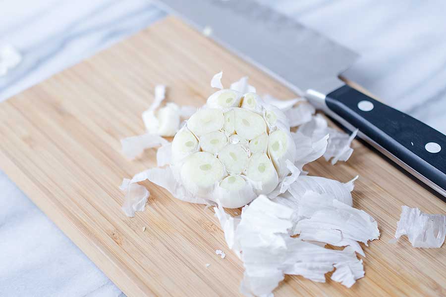 A head of garlic sliced so the cloves are exposed