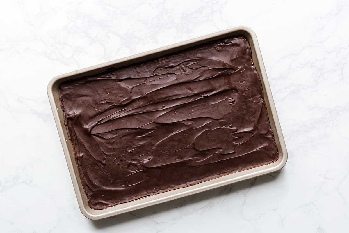 The chocolate layer spread over graham cracker crust.