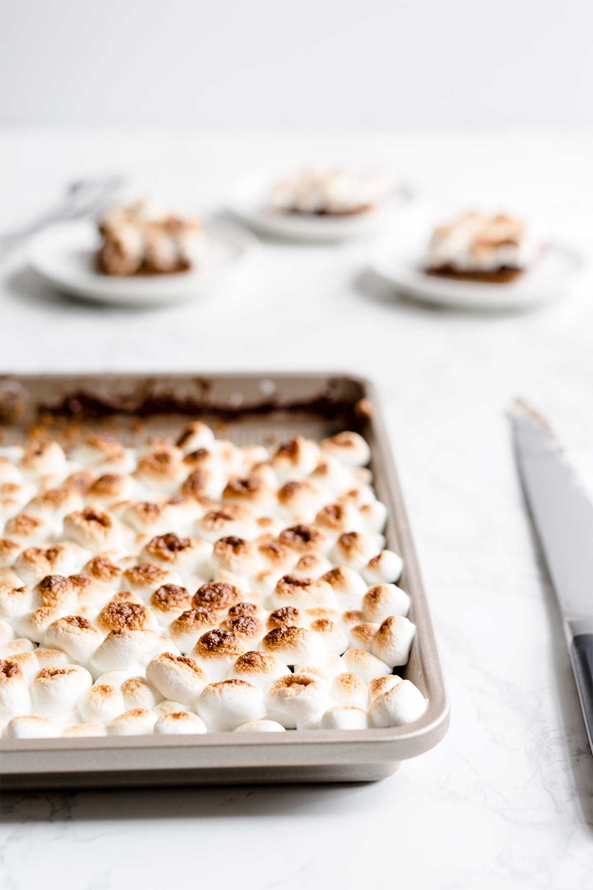 S'mores slab pie in front of 3 slices of pie.