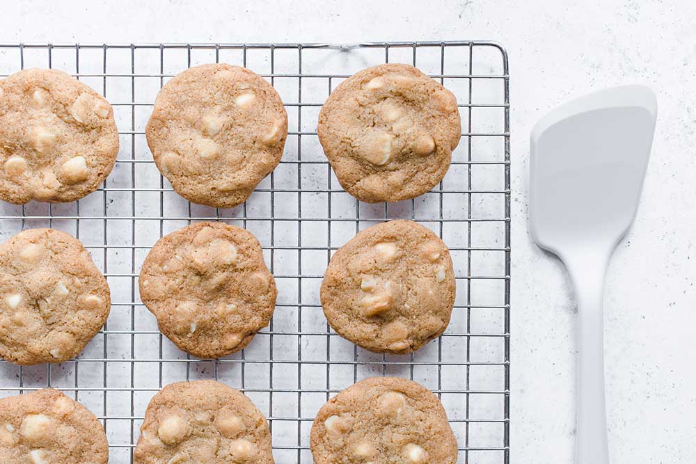 White chocolate chip macadamia nut cookies cooling on a wire rack