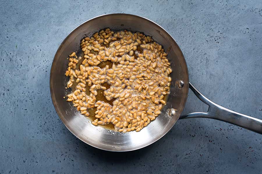 Pine nuts cooked in butter in a skillet