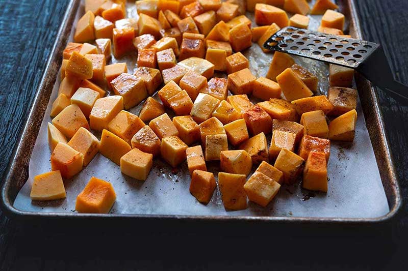 butternut squash cubes on a sheet pan