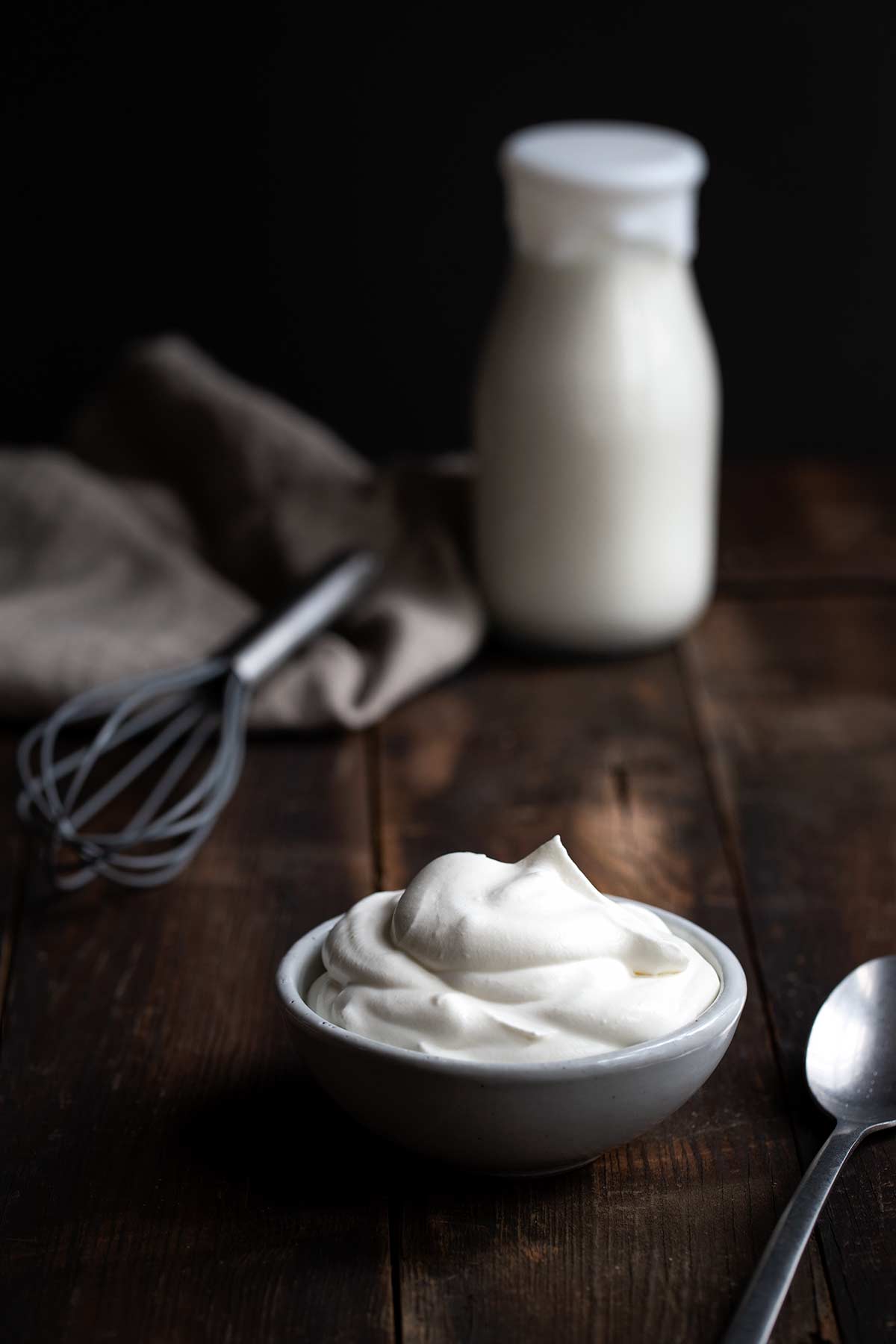 A bowl of whipped cream and a bottle of cream (whipped cream recipe)